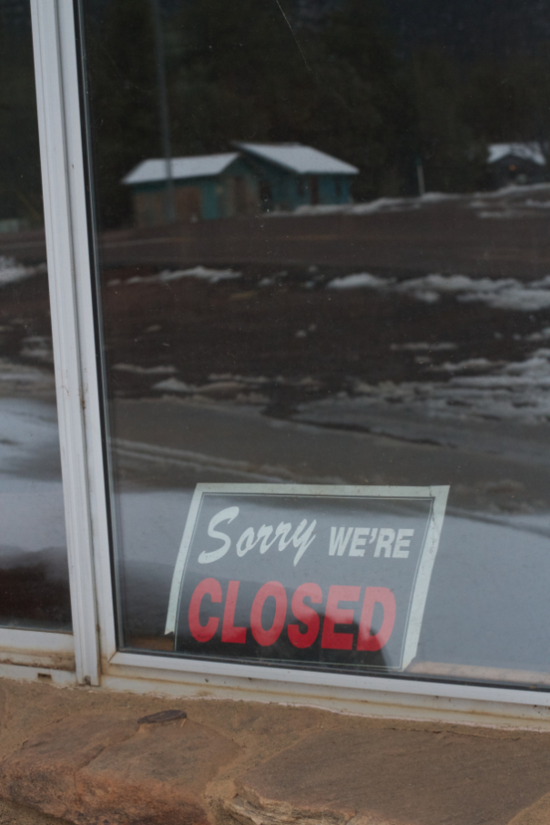 An empty passport office with a “closed” sign